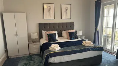 a bedroom with a bed with towels on it at Seaside Escape in Thorpe Bay