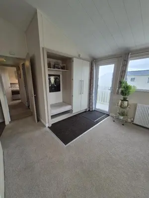 a large room with a large window and a living room at The Blue Lagoon 2 bedroom lodge with hot tub in Walton-on-the-Naze