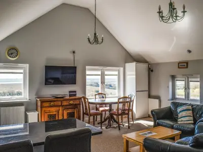 a living room with a couch and a table and chairs at Holly No2 - Uk49254 in Althorne