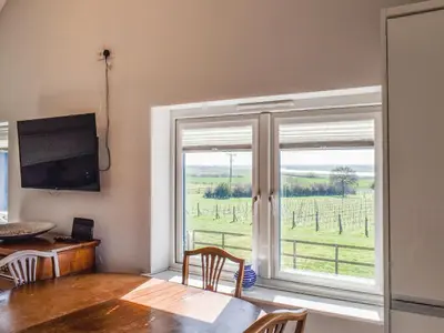 a dining room with a table and a large window at Holly No2 - Uk49254 in Althorne