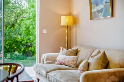 a living room with a couch and a lamp at 2 Bed in Holbrook oc-31111 in Holbrook