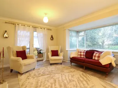 a living room with a couch and two chairs at Crown Farm in Wisbech
