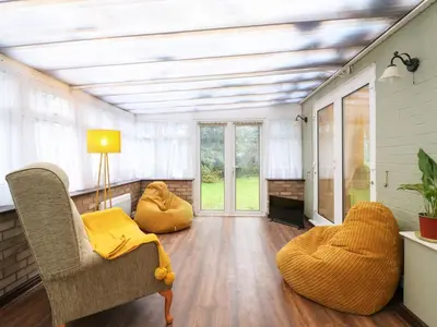 a living room with a couch and a chair at Crown Farm in Wisbech