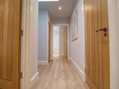 an empty hallway with a door leading to a room at Bradley's Barn in Colchester