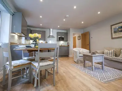 a kitchen and living room with a table and chairs at Bradley's Barn in Colchester