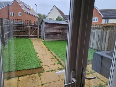 a window view of a yard with a fence at Lovely and Cosy Double Room in Havering atte Bower