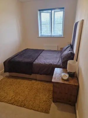 a bedroom with a bed and a table and a window at Lovely and Cosy Double Room in Havering atte Bower