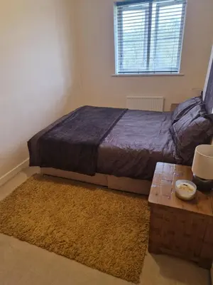 a bedroom with a bed and a coffee table at Lovely and Cosy Double Room in Havering atte Bower