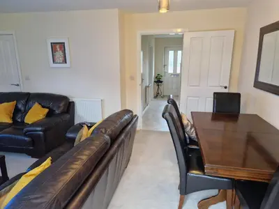 a living room with a couch and a table at Lovely and Cosy Double Room in Havering atte Bower