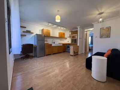 a living room and kitchen with a couch and a table at The Tetris Retreat in Cambridge