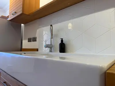 a kitchen counter with a sink and a bottle on it at The Tetris Retreat in Cambridge