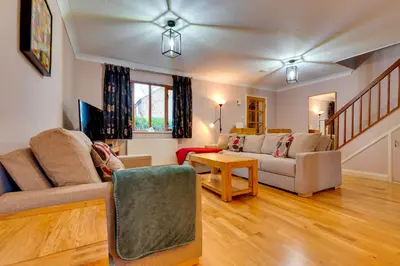 a living room with a couch and a table at Pass the Keys Spacious Modern Home near River Cam Free Parking in Cambridge