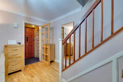 a home with a staircase and a hallway with a door at Pass the Keys Spacious Modern Home near River Cam Free Parking in Cambridge