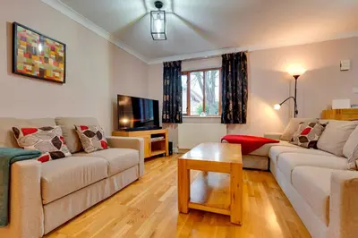 a living room with two couches and a tv at Pass the Keys Spacious Modern Home near River Cam Free Parking in Cambridge