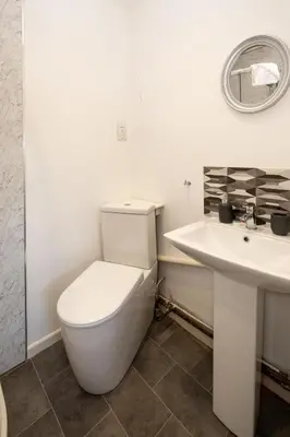 a bathroom with a white toilet and a sink at 51 The Plantation - Aldeburgh Coastal Cottages in Aldeburgh