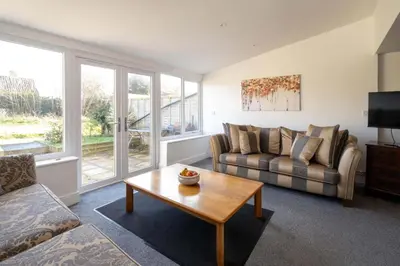 a living room with a couch and a coffee table at 51 The Plantation - Aldeburgh Coastal Cottages in Aldeburgh