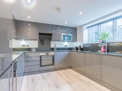 a kitchen with stainless steel appliances and a large window at 4-Bedroom Seafront House in Southend Sea Views - Pass the Keys in Southend-on-Sea