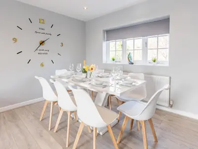 a white dining room with a white table and chairs at 4-Bedroom Seafront House in Southend Sea Views - Pass the Keys in Southend-on-Sea