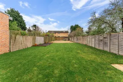 a backyard with a fence and green grass at Gorgeous Abode in Cambridge - Pet Friendly! in Cherry Hinton