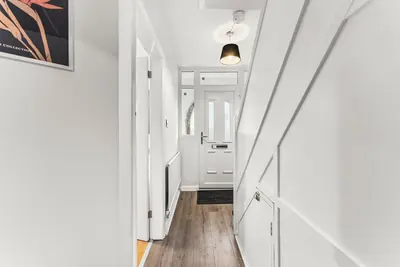 a hallway with white walls and a white door at Gorgeous Abode in Cambridge - Pet Friendly! in Cherry Hinton