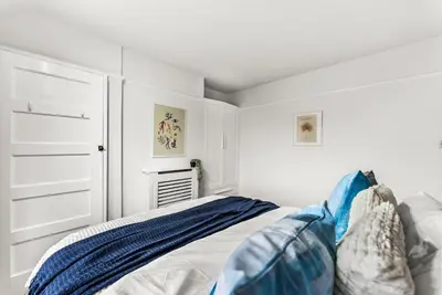 a white bedroom with a bed and a closet at Gorgeous Abode in Cambridge - Pet Friendly! in Cherry Hinton