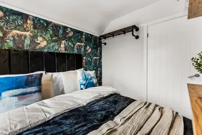 a bedroom with a bed with a mural on the wall at Gorgeous Abode in Cambridge - Pet Friendly! in Cherry Hinton