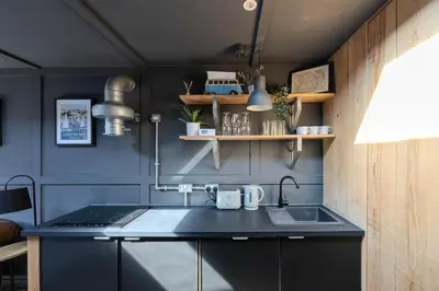 a kitchen with a sink and a counter top at The Stables in Southend-on-Sea