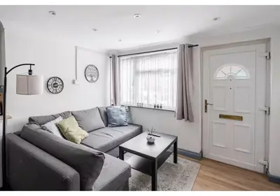 a living room with a gray couch and a table at The Barack Nest Colchester in Colchester