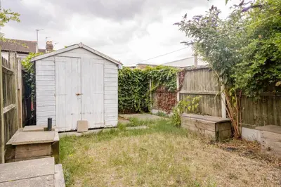 a garden with a shed and a fence at The Barack Nest Colchester in Colchester