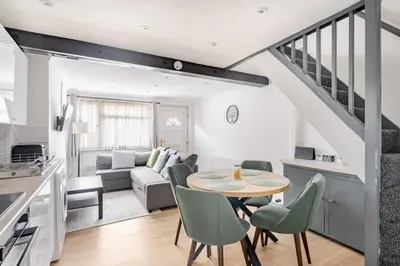 a kitchen and living room with a table and chairs at The Barack Nest Colchester in Colchester