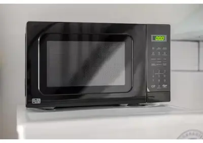 a microwave oven sitting on top of a stove at The Barack Nest Colchester in Colchester
