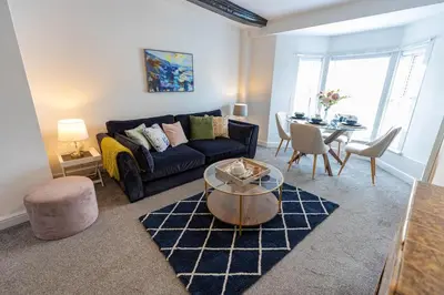 a living room with a couch and a table at Brandon Apartment in Town Centre with parking in Brandon
