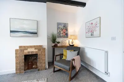 a living room with a fireplace and a chair at Brandon Apartment in Town Centre with parking in Brandon