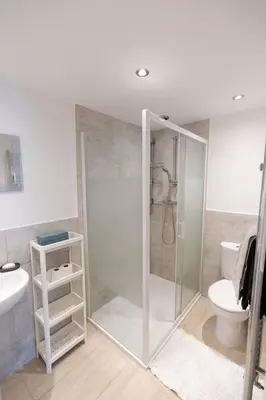 a bathroom with a shower and a toilet at Brandon Apartment in Town Centre with parking in Brandon