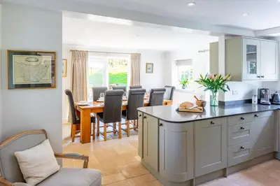 a kitchen and dining room with a table and chairs at Marvellous secluded forest lodge - Stone Hall in Eyke