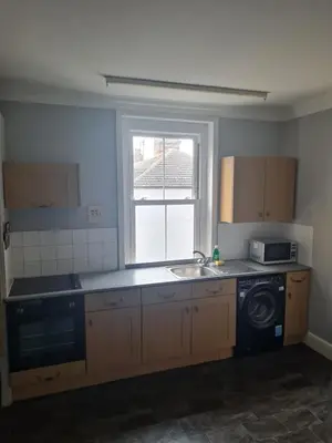 a kitchen with a sink and a washing machine at The Harwich Hideaway in Harwich