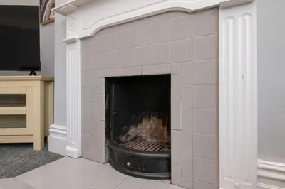 a brick fireplace in a living room at The Harwich Hideaway in Harwich