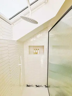 a bathroom with a shower with a glass door at Bright Mews House with Garage in Heart of Cambridge in Cambridge