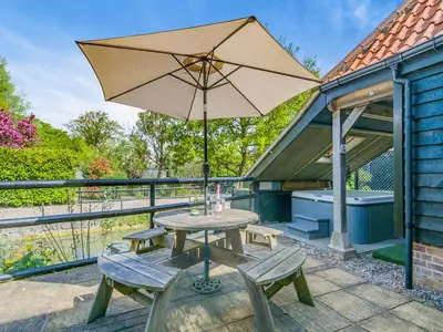 a table and chairs with an umbrella on a patio at Ash - Uk49524 in Saint Lawrence