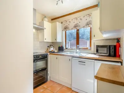 a kitchen with white cabinets and a sink and a microwave at Ash - Uk49524 in Saint Lawrence