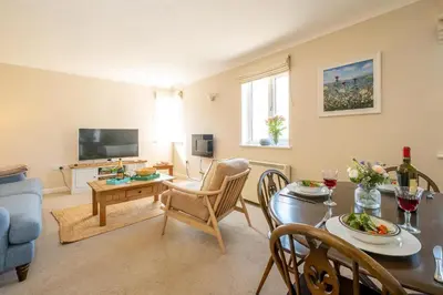 a living room with a table and a dining room at 3 St Johns Court - Aldeburgh Coastal Cottages in Aldeburgh