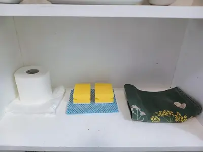 two towels and a roll of toilet paper on a shelf at Central en-suite room, WIFI, Kitchen and Laundry Access - room 5 in Ipswich