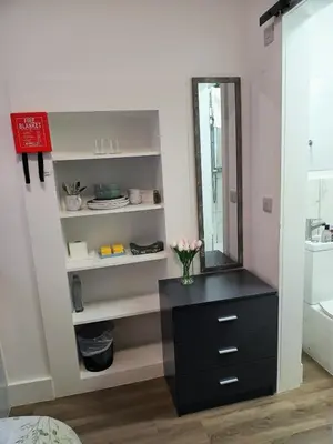 a bathroom with a black dresser and a mirror at Central en-suite room, WIFI, Kitchen and Laundry Access - room 5 in Ipswich
