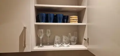 a cupboard with glasses and wine glasses at Spacious Colchester Home with Off-Street Parking for 4 cars in Colchester