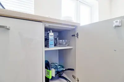 a kitchen with a door open with a sink at Spacious Colchester Home with Off-Street Parking for 4 cars in Colchester