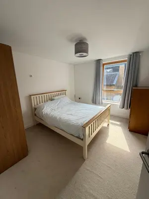 a bedroom with a bed in a room with a window at Spacious 4 Bedroom Townhouse in Essex in Burnt Mill