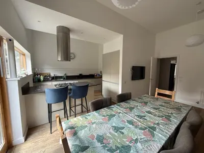 a dining room and kitchen with a table and chairs at Spacious 4 Bedroom Townhouse in Essex in Burnt Mill