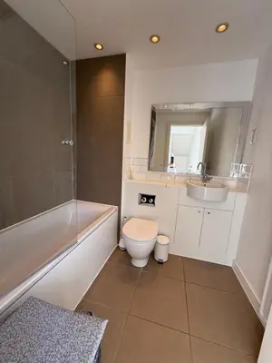a bathroom with a toilet and a tub and a sink at Spacious 4 Bedroom Townhouse in Essex in Burnt Mill