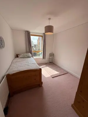 a bedroom with a bed and a window at Spacious 4 Bedroom Townhouse in Essex in Burnt Mill