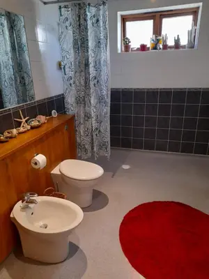 a bathroom with a toilet and a sink at Wisteria Barn in Harleston